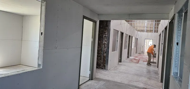 Commercial drywall installation in a hallway build-out