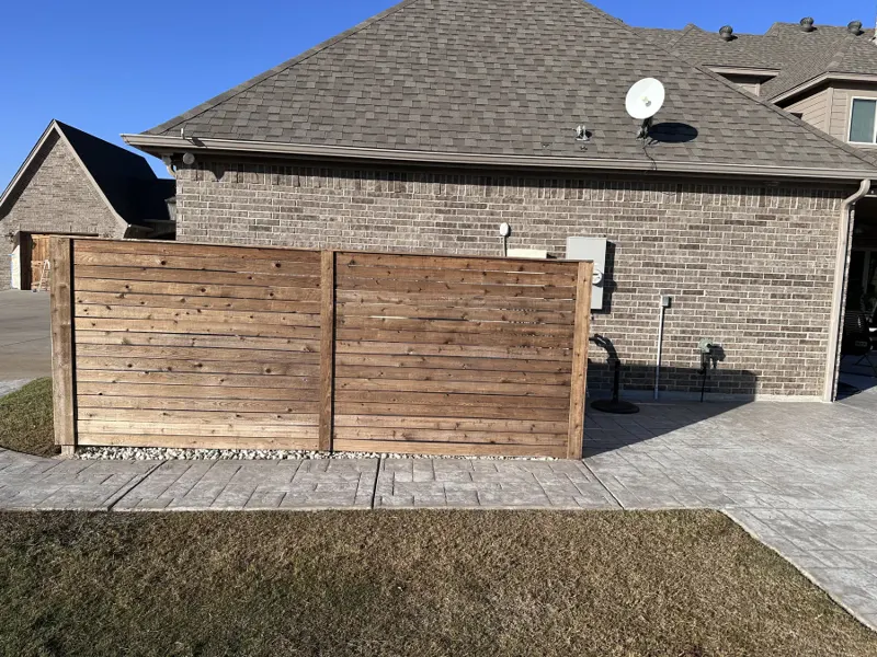 Freshly stained wood privacy fence
